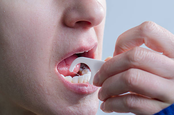 istock Close up on woman no makeup with dental floss stick 493245934