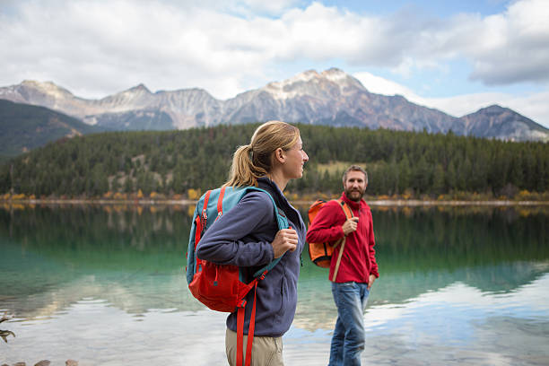 istock Two young adults hiking by the lake 493246618