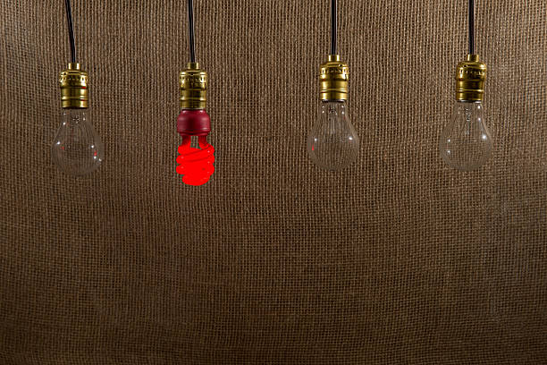 istock Hanging Red CFL and Incandescent Bulbs 493246823