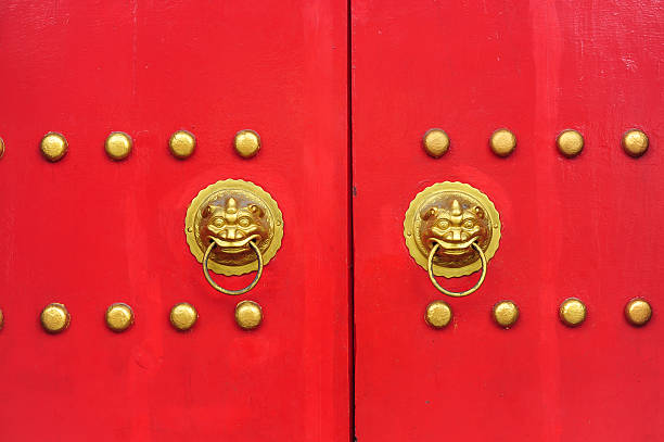 istock Red chinese door with a lion hand door 493246985