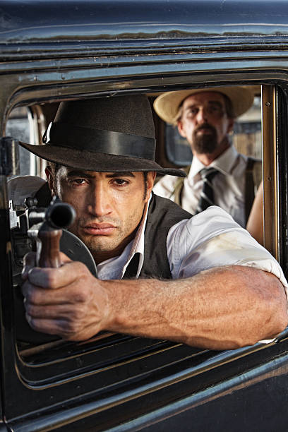 istock Muscular Gangster Shooting Gun 493247041