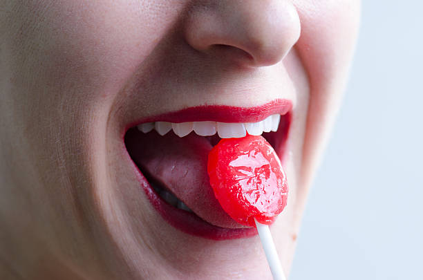 istock Close up on woman licking a red lollipop 493247598