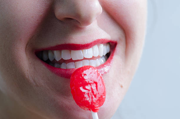 istock Close up on woman licking a red lollipop 493247700