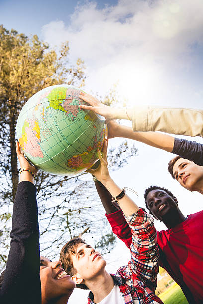 istock Group of teenagers holding an earth globe 493250207