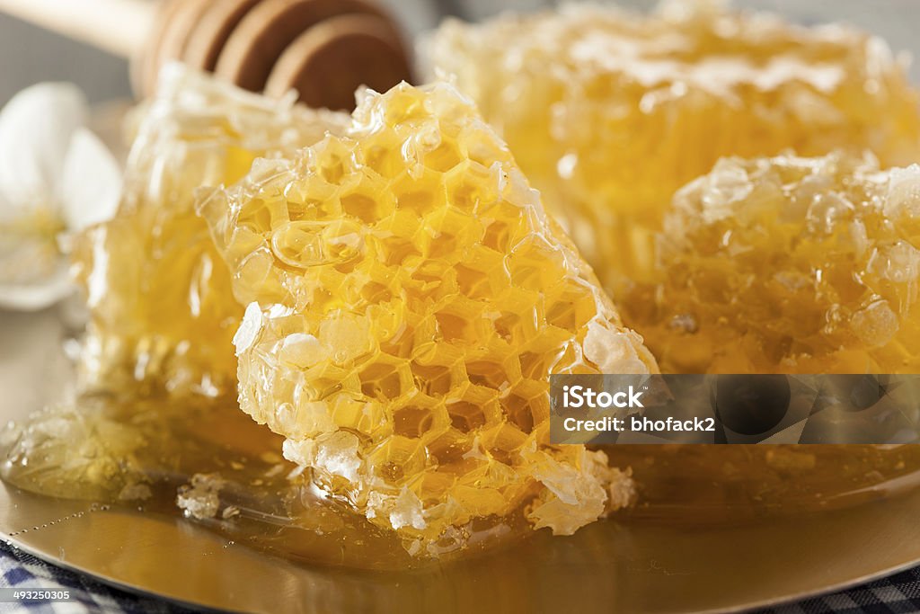 Organic Raw Golden Honey Comb Organic Raw Golden Honey Comb on a Background Amber Stock Photo