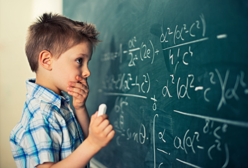 Little boy in math class overwhelmed by the math formula.