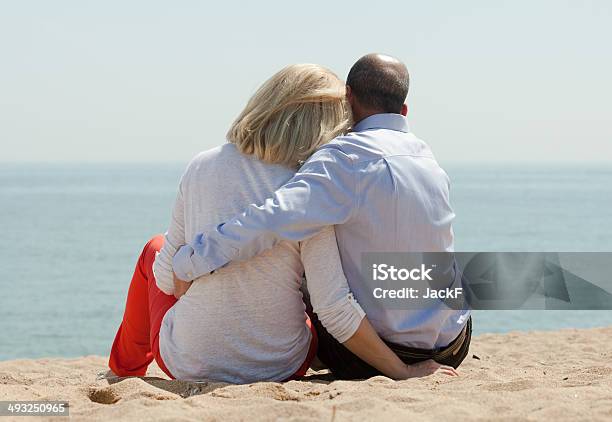 Mature Lovers Sitting On Beach Stock Photo - Download Image Now - 50-54 Years, Couple - Relationship, Love - Emotion