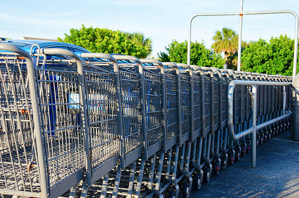 Row of shopping carts in outdoor return station stock photo