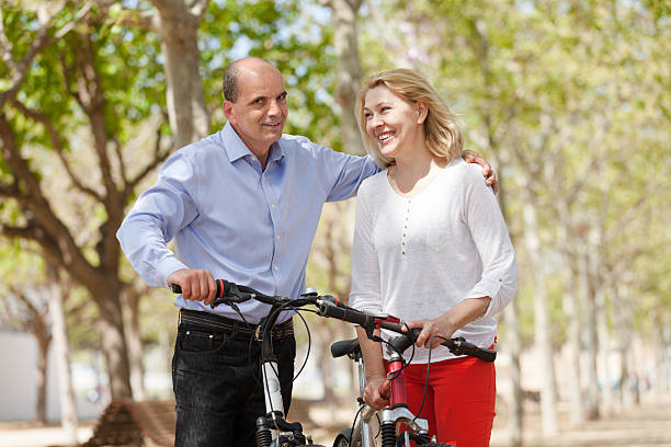 istock Happy couple walking with bicycles 493251343
