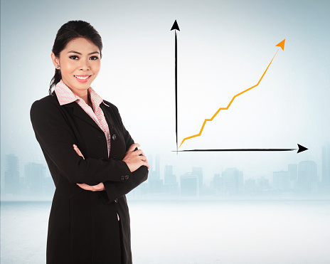 Asian business woman smiling over chart on the background
