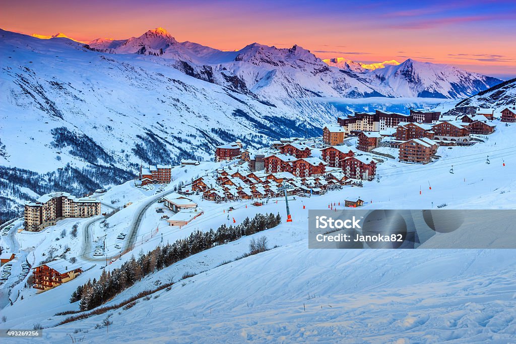 Amazing sunrise and ski resort in the French Alps,Europe Majestic winter sunrise landscape and ski resort with typical alpine wooden houses in French Alps,Les Menuires,3 Vallees,France,Europe Les Menuires Stock Photo