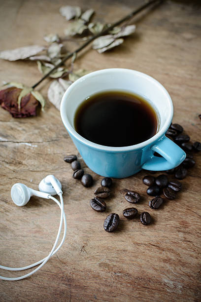 istock earphone with coffee on old wooden table 493269856