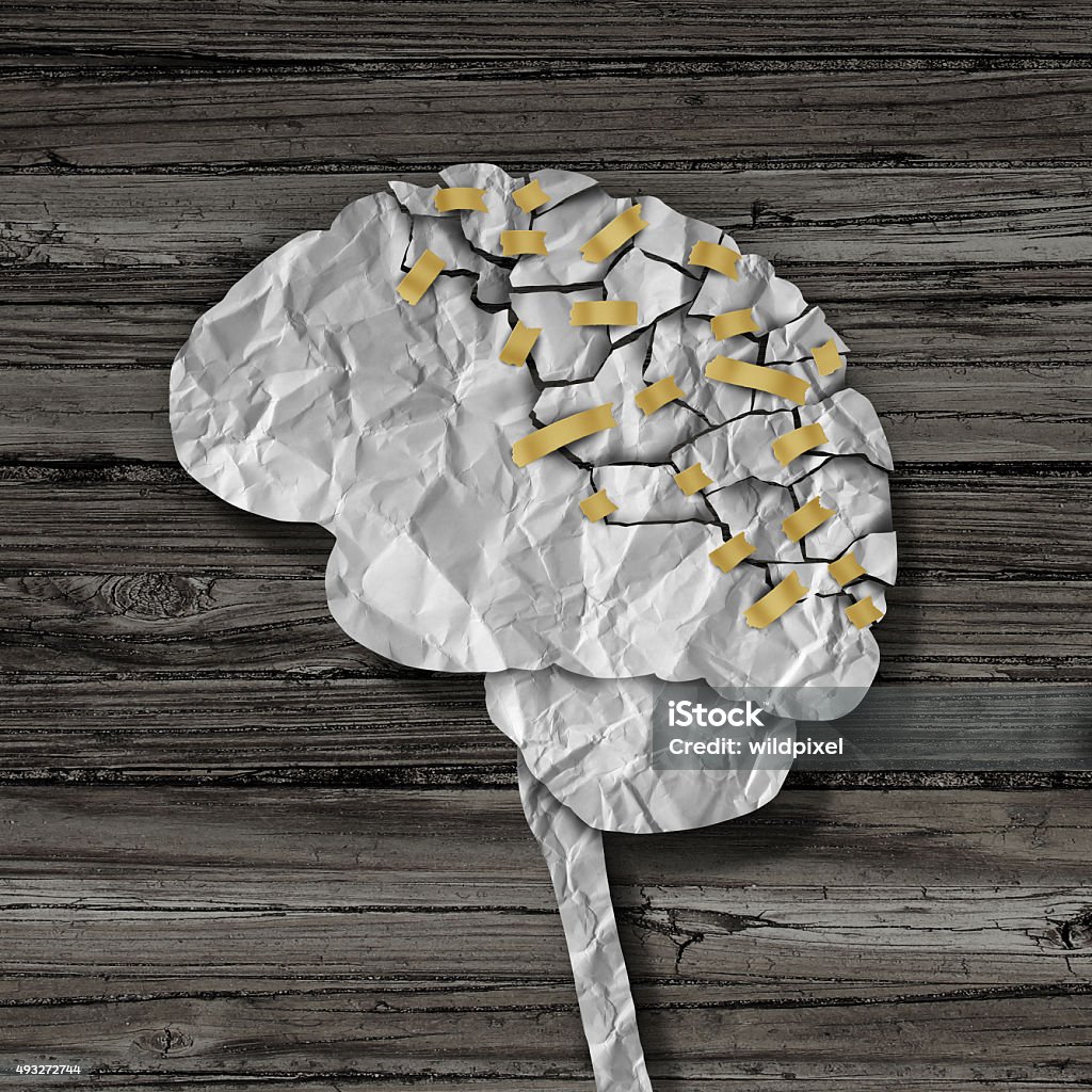 Brain Rehabilitation Brain rehabilitation and mental health therapy concept as a crumpled broken paper shaped as the human thinking organ repaired together with tape as a neurology medical treatment symbol. Multiple Sclerosis Stock Photo