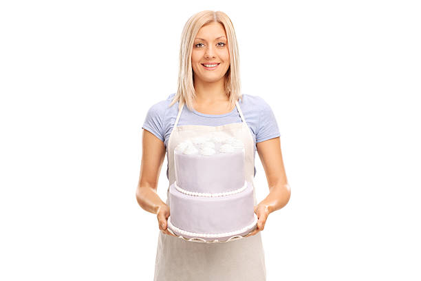 istock Female pastry chef carrying a large cake 493275922