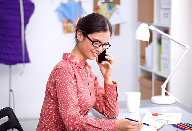 istock Clothes designer talking on the phone 493275982