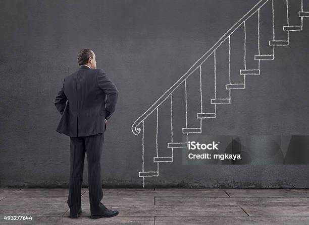 Businessman With Staircase Sketched On The Wall Stock Photo - Download Image Now - 2015, Adult, Bannister
