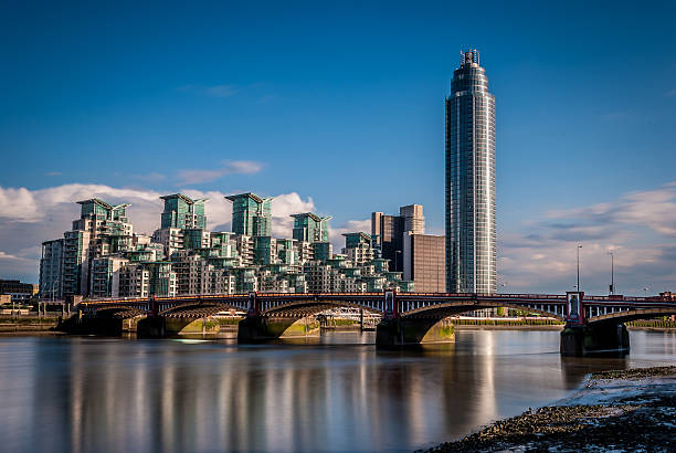 Luxury riverside apartments Vauxhall Bridge on the foreground.On the background is St George Warf. mi6 stock pictures, royalty-free photos & images