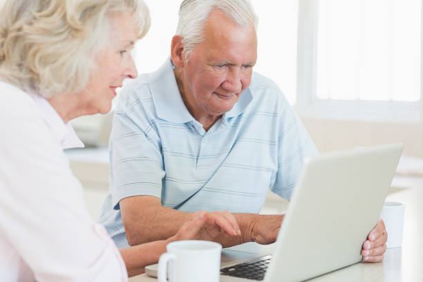 istock Concentrated senior man and woman using laptop 493278415