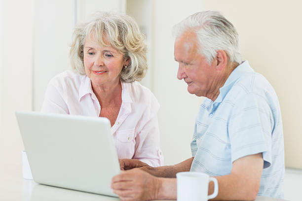 istock Concentrated senior man and woman using laptop 493278419