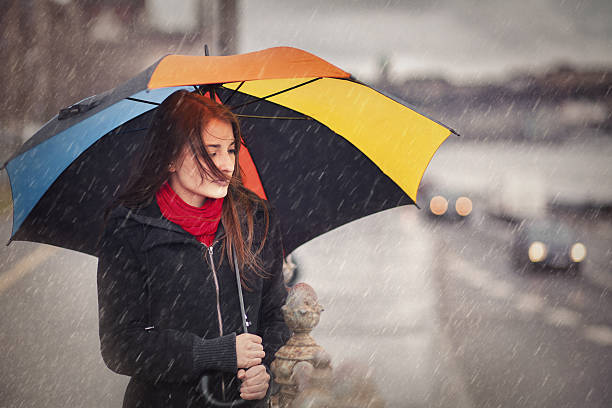 istock girl with umbrella on a rainy day 493279427