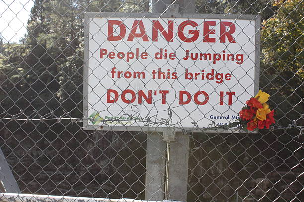 istock Sign over bridge stopping people jumping into rapids below 493279447