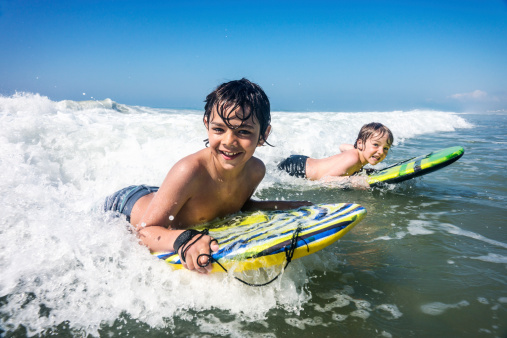 Two brothers enjoying the surf on vacation in North Carolina.