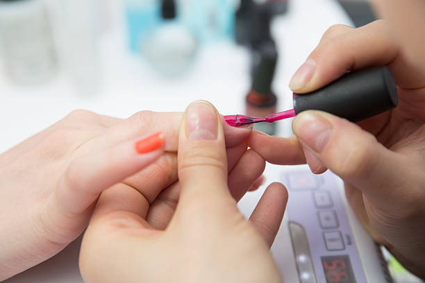 istock paint your nails pink polish 493279873