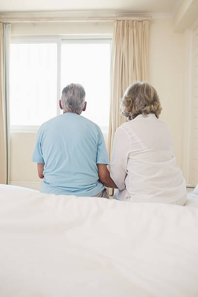 istock Rear view of a senior couple sitting on bed 493281221