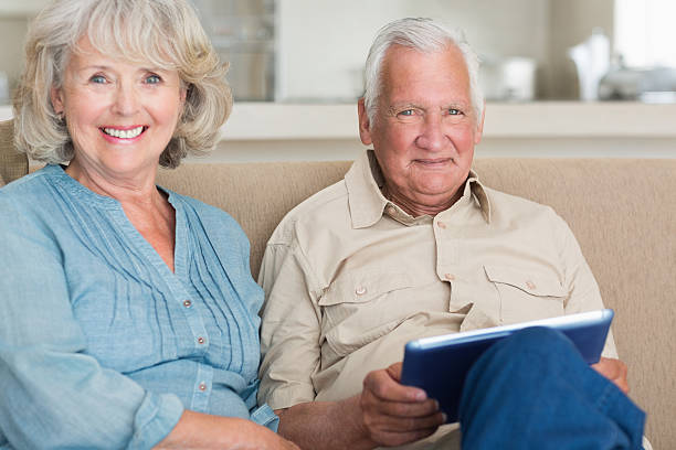 istock Portrait of smiling senior couple using digital tablet 493281233
