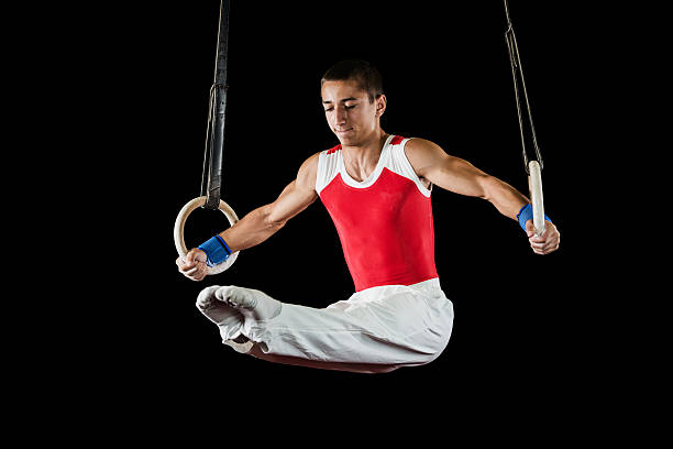 istock Young man on gymnastics rings. 493281593