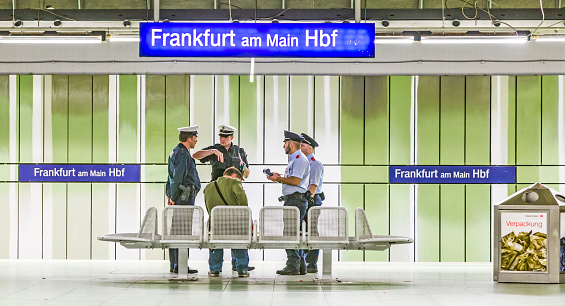 Frankfurt, Germany - March 29, 2014:  railway police checks a passenger for a valid ticket  in Frankfurt, Germany. Travel without valid ticket is charged with 50 EUR fine.