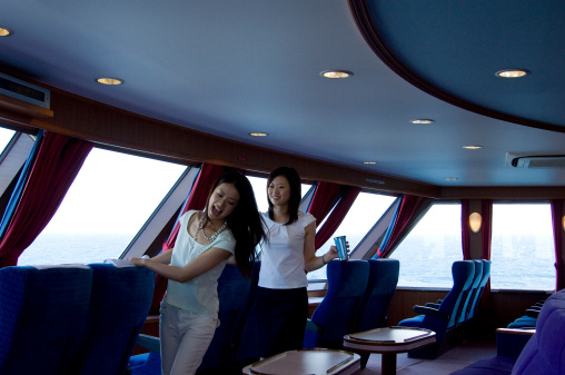 Two Young Japanese women spending times in ferry