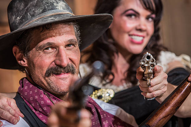 istock Cowboy and Saloon Girl Point Weapons 493282301