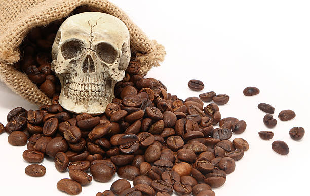 istock Skull on sack of coffee bean roasted on white background 493282446