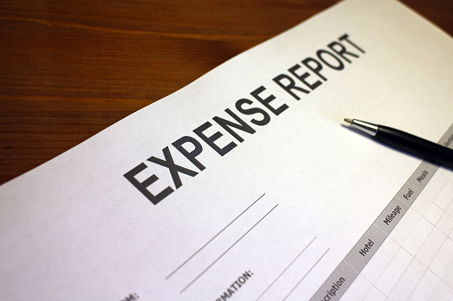 Someone filling out Expense Report Form