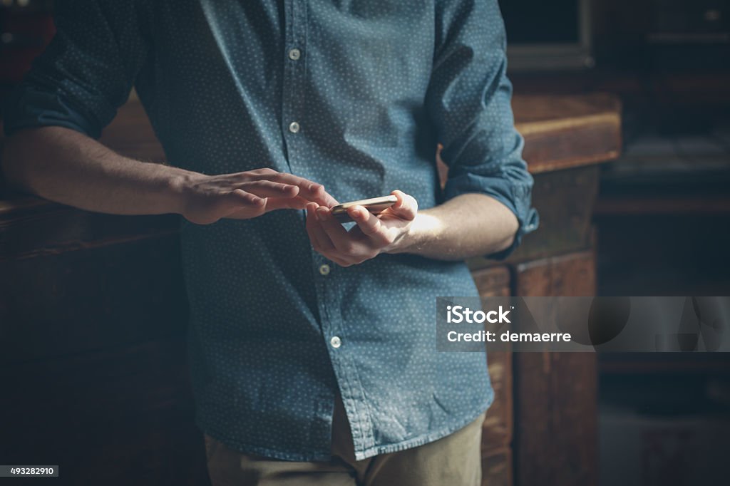 Young hipster using a mobile phone Hipster using a touch screen smart phone hands close up, vintage colors Close-up Stock Photo