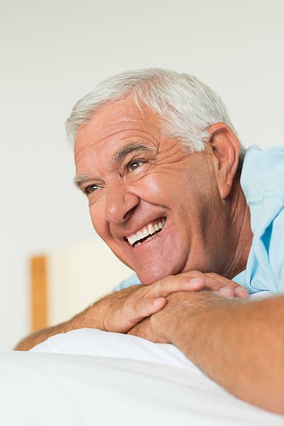 istock Happy senior man on bed 493283107