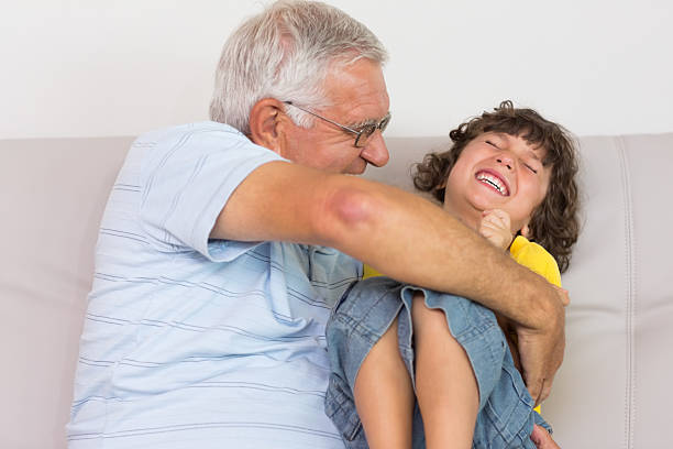 istock Grandfather tickling grandson 493283159