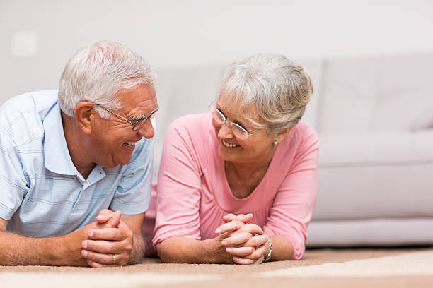 istock Cheerful senior couple lying on floor 493284927