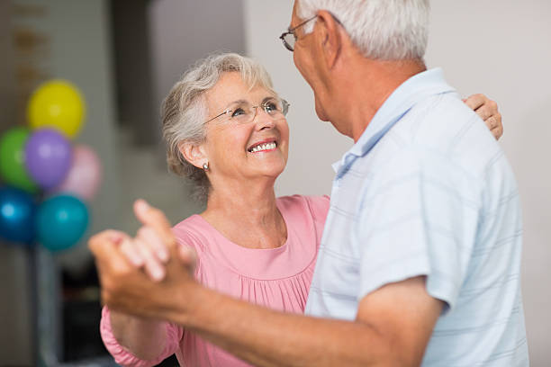 istock Romantic senior couple dancing at home 493284945