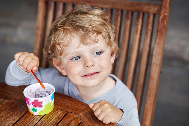 istock Little toddler eating ice cream summer 493285049