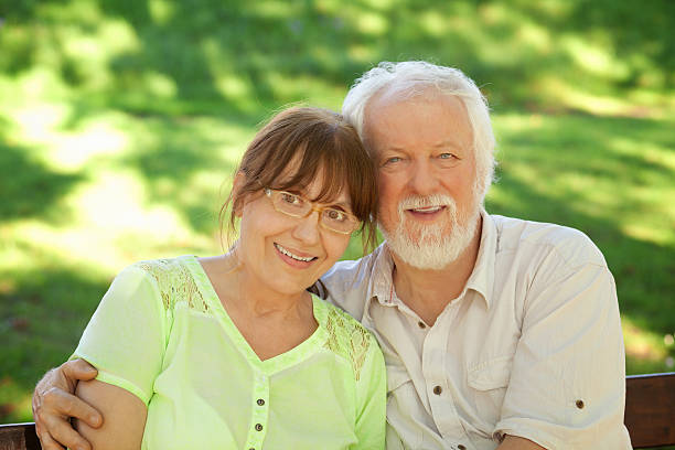 istock Senior couple sitting on a park bench 493302500