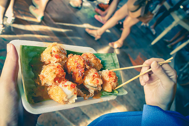 istock Holding mini Fried Mussels in Batter on vintage tone 493302706