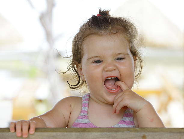 istock Laughing happy baby girl on bench 493302932
