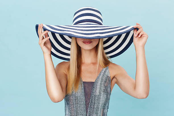 istock Sun hat obscuring beautiful woman in studio 493303108