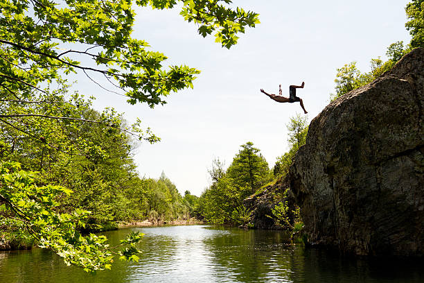 istock Free jump from a rock in the river 493303338