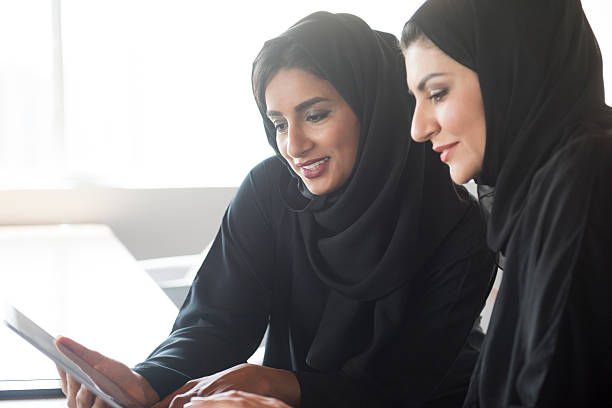 istock Two Middle Eastern businesswomen wearing hijabs using tablet 493303970