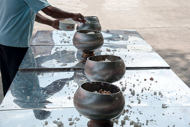 istock give food offerings to a Buddhist monk 493304074