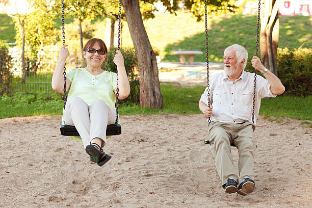 istock Senior couple swinging in the park 493304358