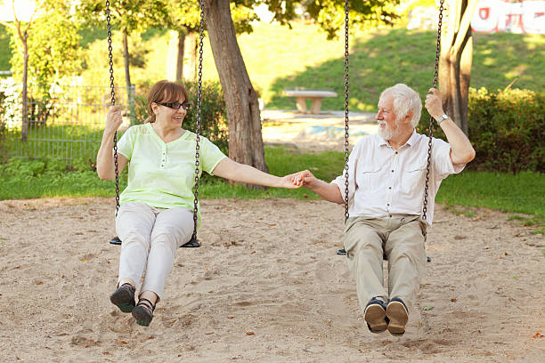 istock Senior couple swinging in the park 493304796